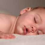 Why does a baby breathe often in his sleep?
